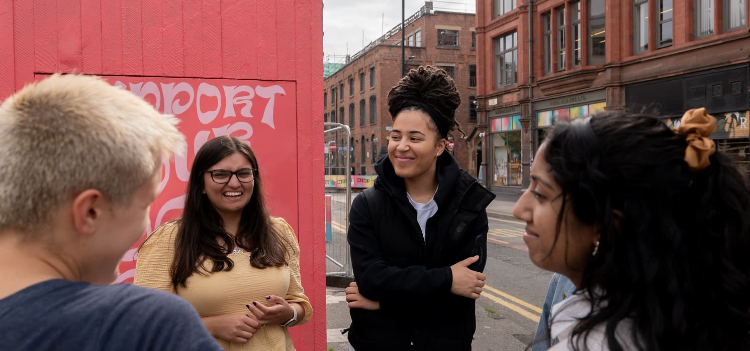 Young people talking outside at an event