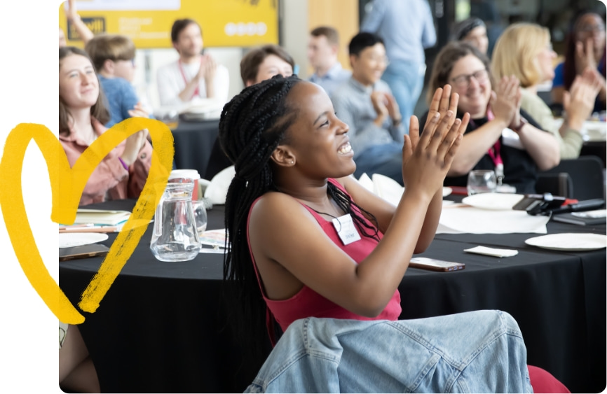 Audience clapping at iWill event